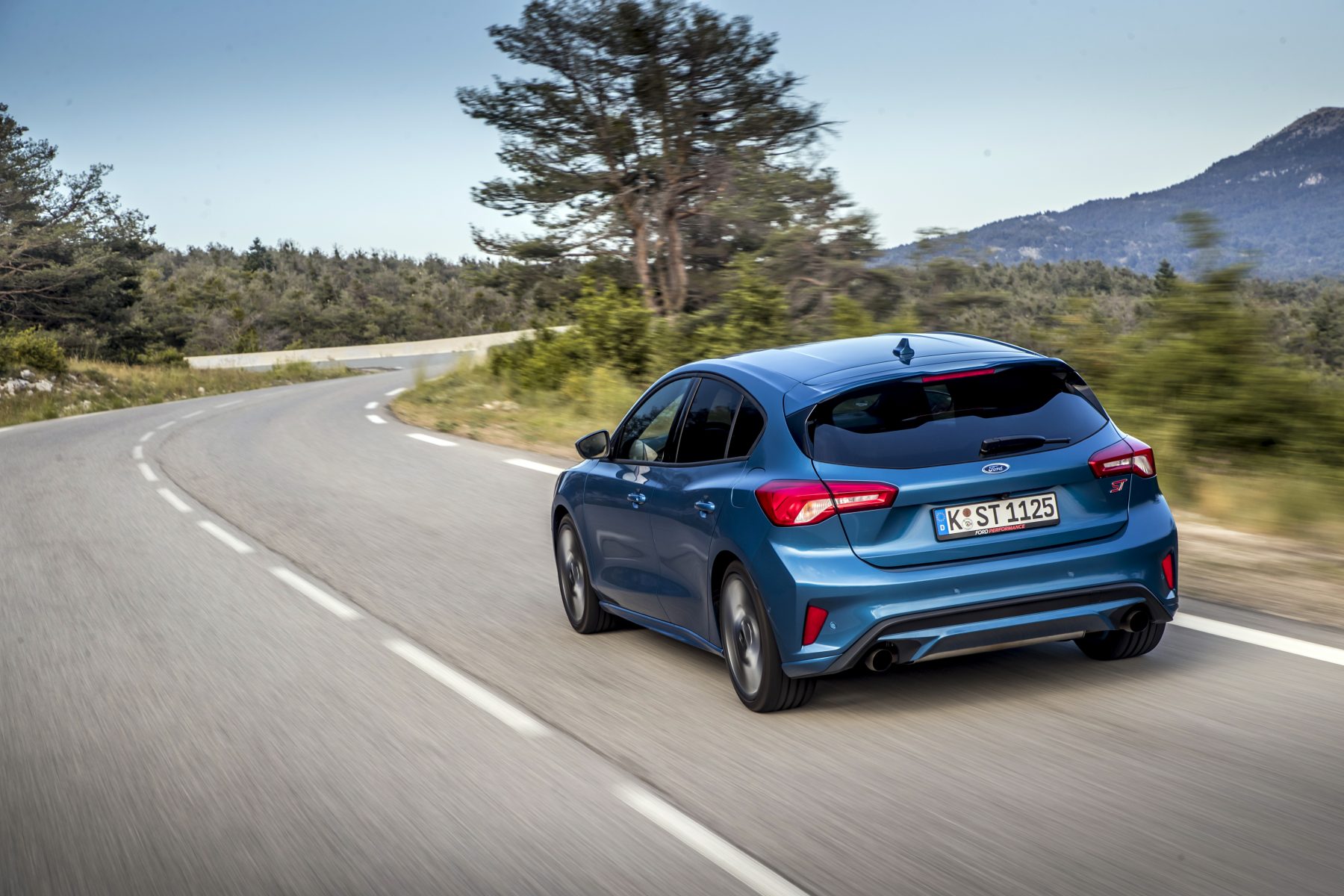 rear view of Ford Focus ST driving on a road
